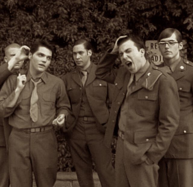 soldiers standing together in a casual setting, not in full uniform